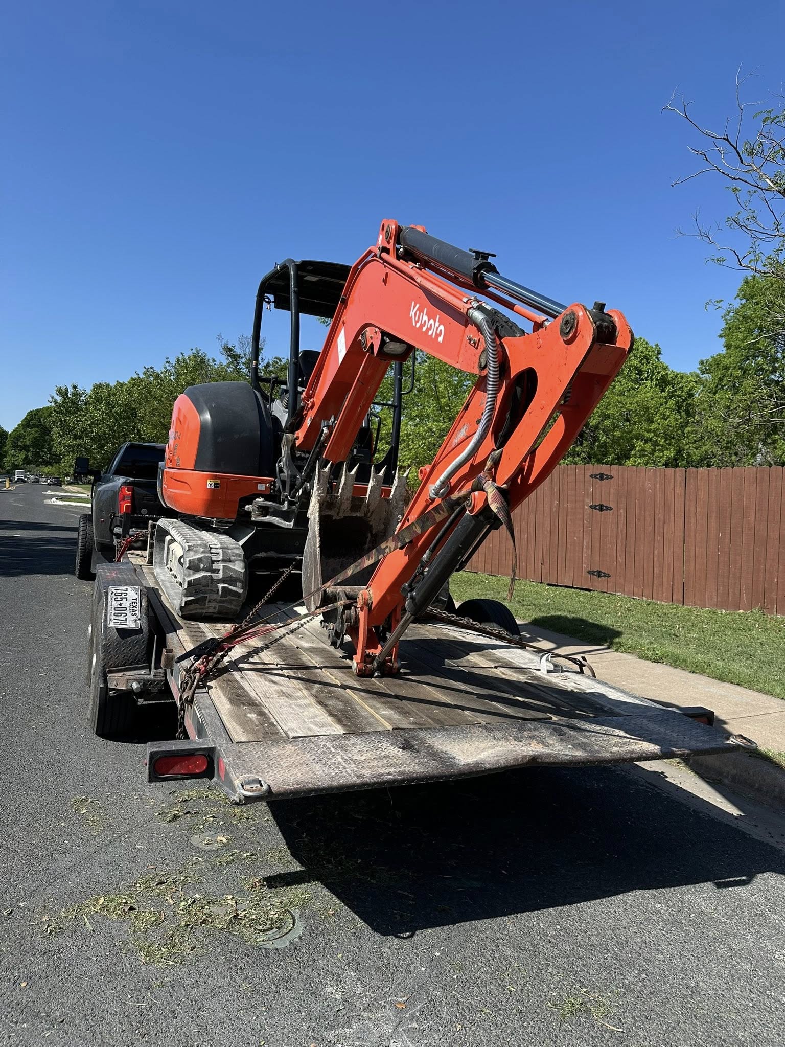Kubota mini excavator secured on flatbed for transport